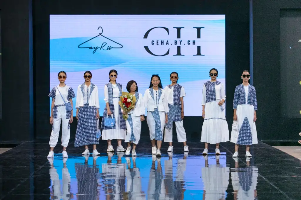 Zayru x CEHA.BY.CH runway show — models walking in blue-and-white shibori-style ensembles.